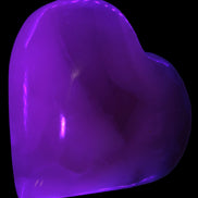 Mangano Calcite hand-carved heart 67-94mm  129-274g in UV light - Rocks and Things Store