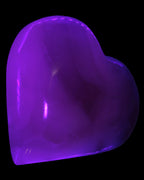 Mangano Calcite hand-carved heart 67-94mm  129-274g in UV light - Rocks and Things Store