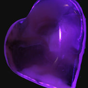 Mangano Calcite hand-carved heart 67-94mm  129-274g in UV light - Rocks and Things Store