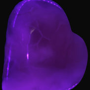 Mangano Calcite hand-carved heart 67-94mm  129-274g in UV light - Rocks and Things Store