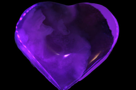 Mangano Calcite hand-carved heart 67-94mm  129-274g in UV light - Rocks and Things Store