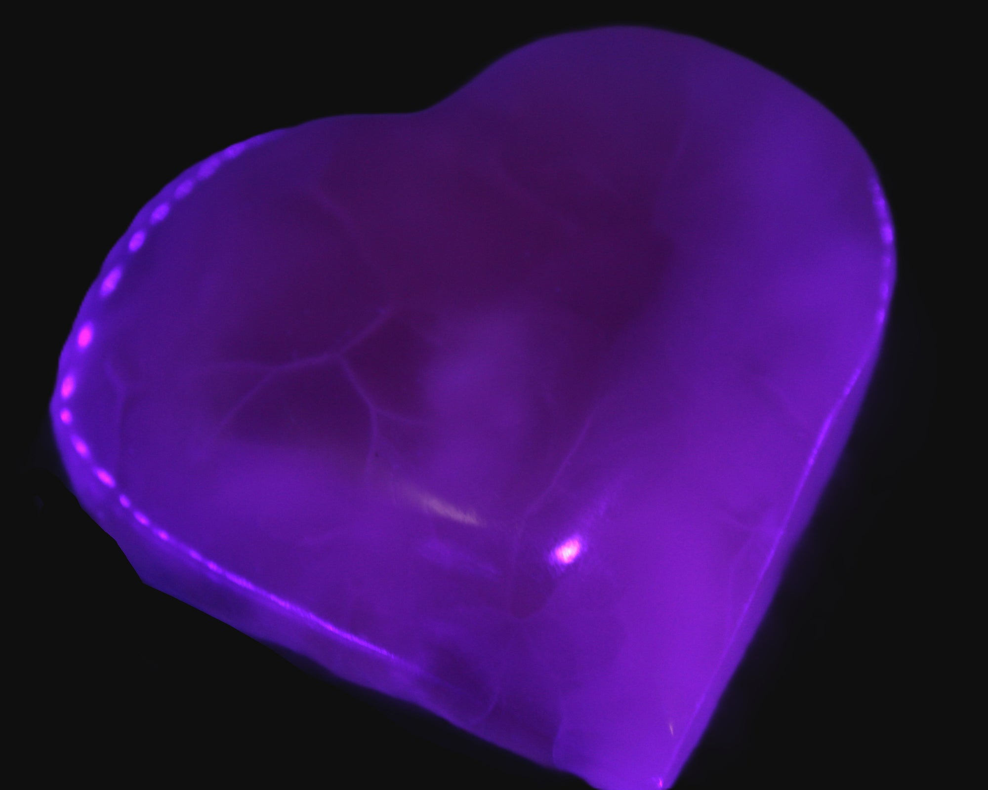 Mangano Calcite hand-carved heart 67-94mm  129-274g in UV light - Rocks and Things Store