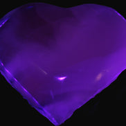 Mangano Calcite hand-carved heart 67-94mm  129-274g in UV light - Rocks and Things Store