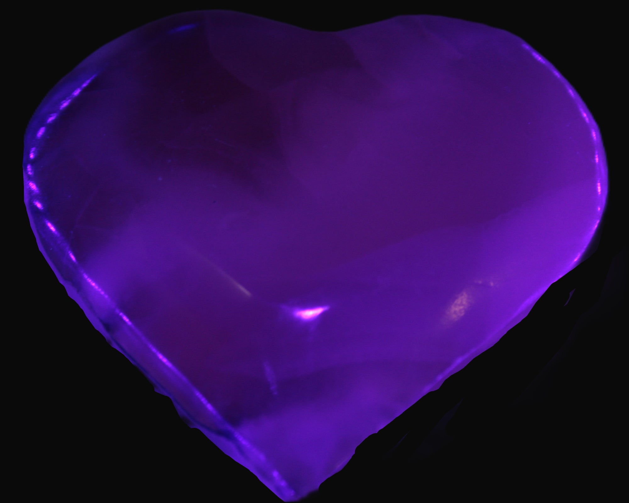 Mangano Calcite hand-carved heart 67-94mm  129-274g in UV light - Rocks and Things Store