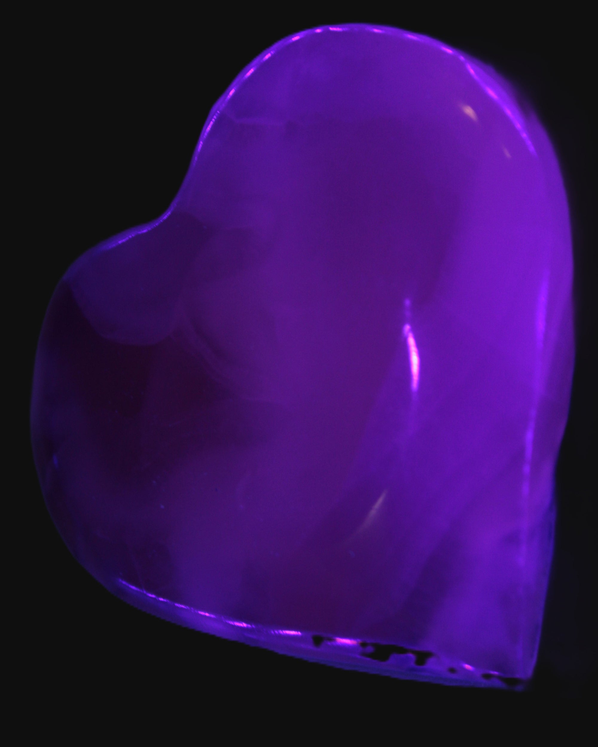 Mangano Calcite hand-carved heart 67-94mm  129-274g in UV light - Rocks and Things Store