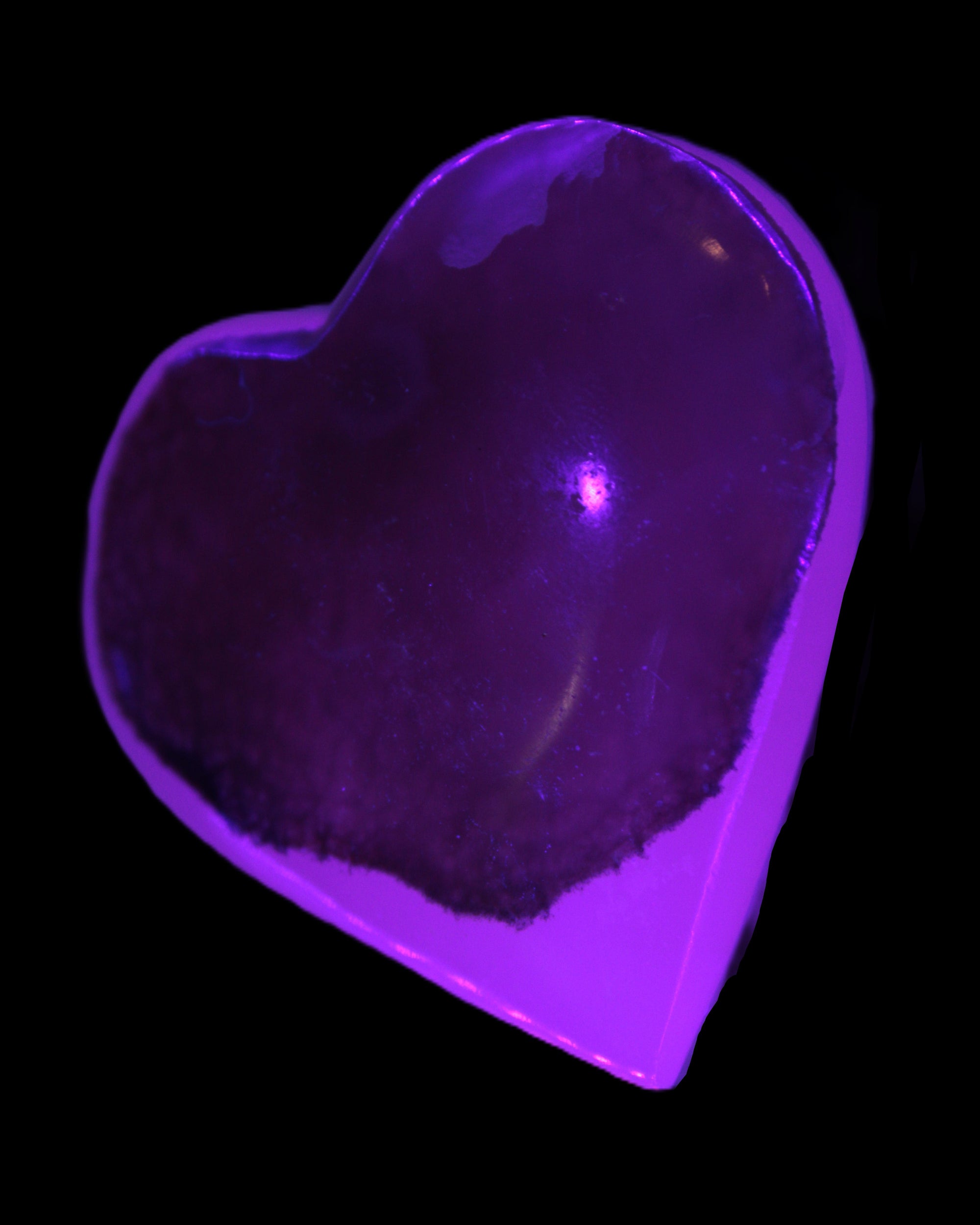Mangano Calcite hand-carved heart 60-65mm  112-117g in UV light - Rocks and Things Store
