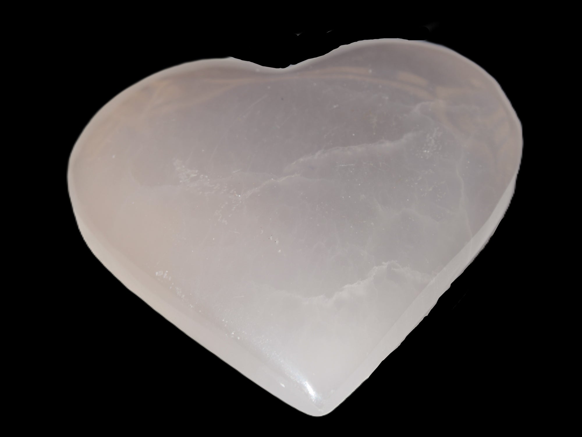 Mangano Calcite hand-carved heart 60-65mm  112-117g in sunlight -  Rocks and Things Store