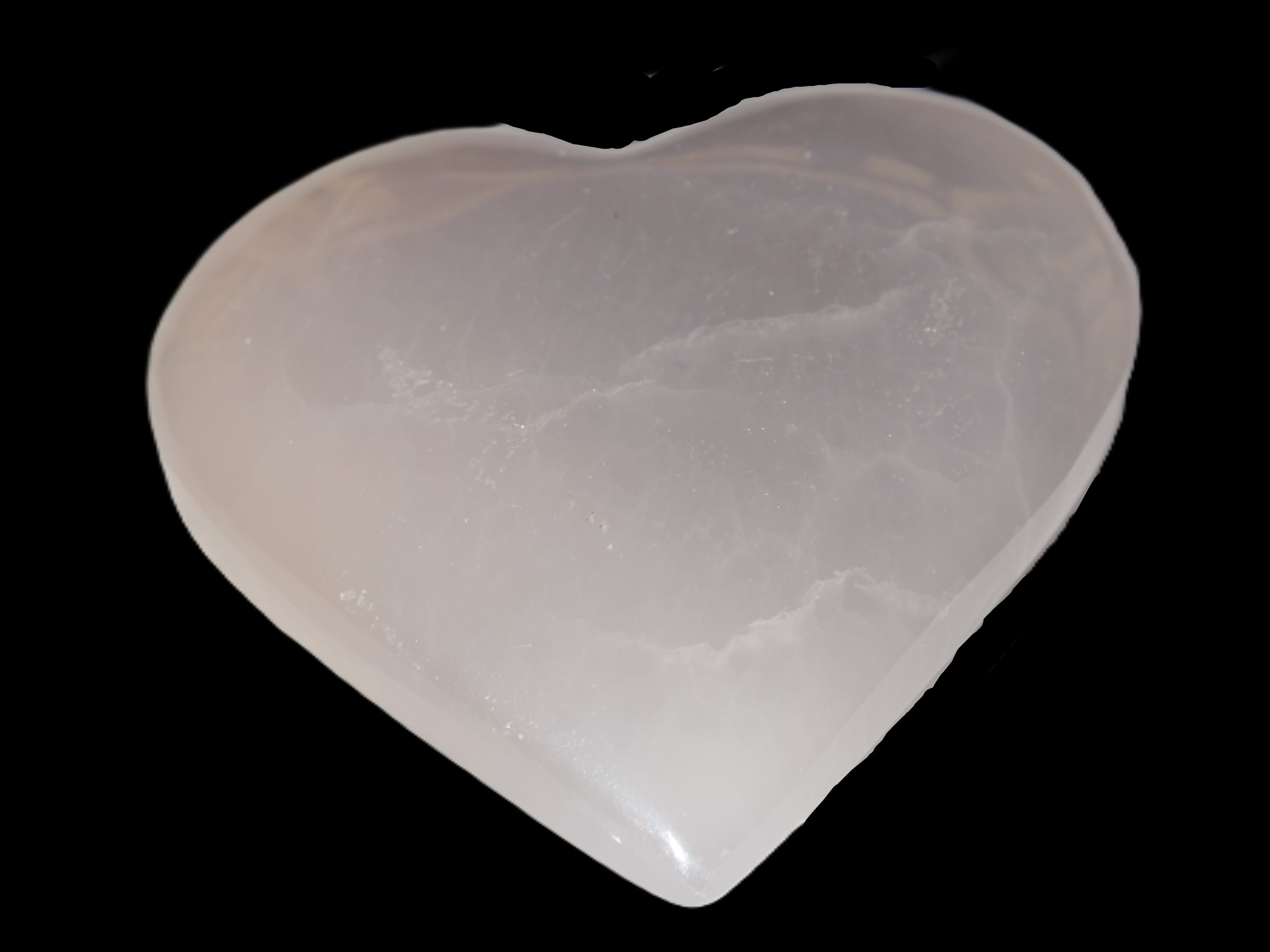 Mangano Calcite hand-carved heart 60-65mm  112-117g in sunlight -  Rocks and Things Store