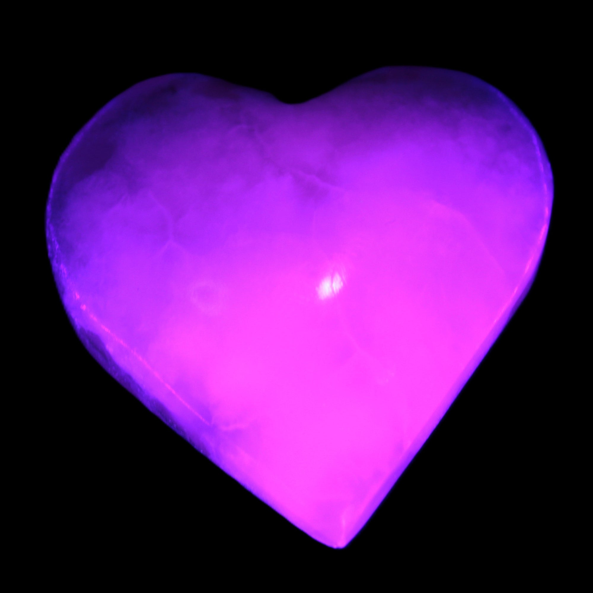 Mangano Calcite hand-carved heart 47-49mm 58-66g in UV light - Rocks and Things Store