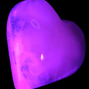 Mangano Calcite hand-carved heart 47-49mm 58-66g in UV light - Rocks and Things Store