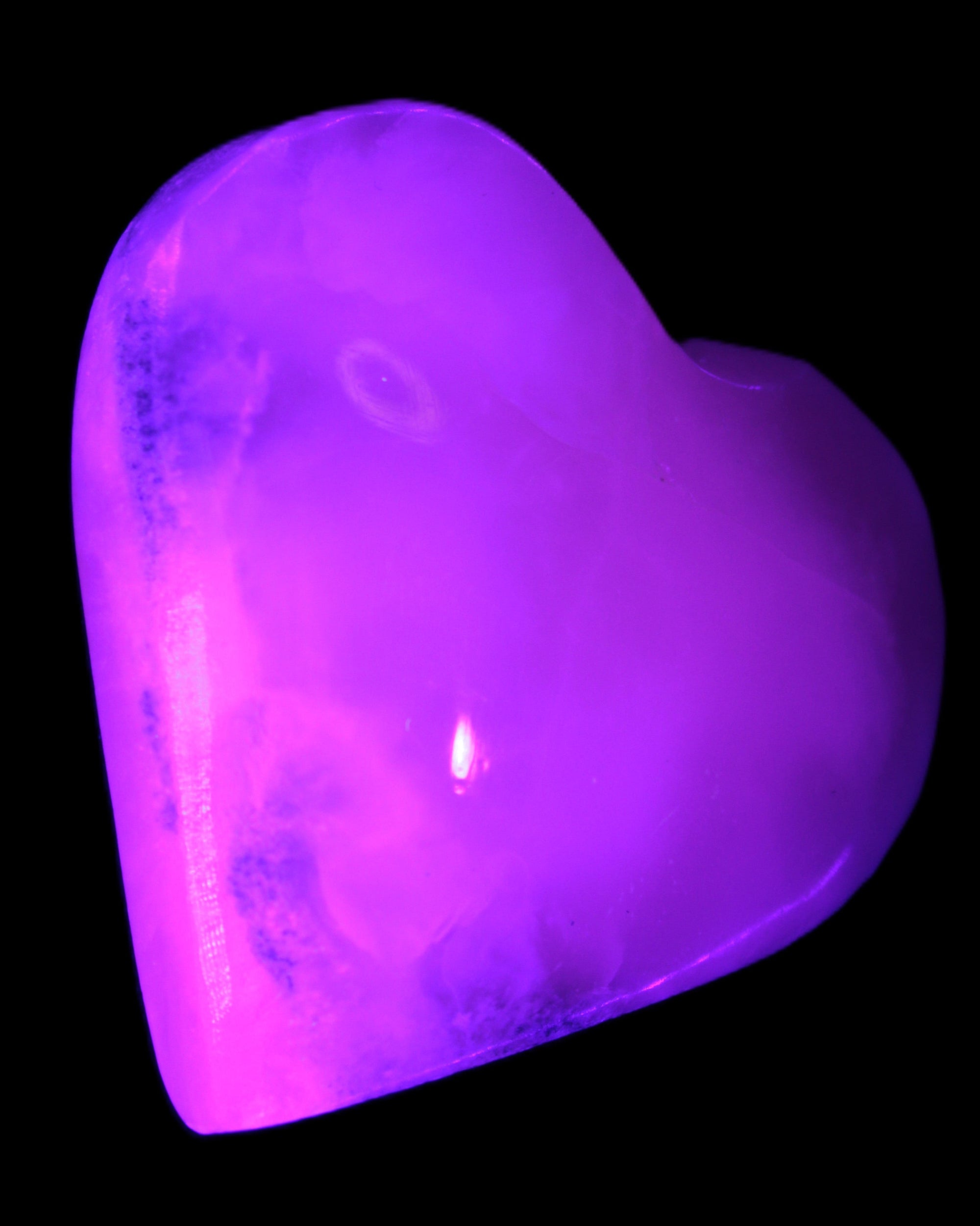 Mangano Calcite hand-carved heart 47-49mm 58-66g in UV light - Rocks and Things Store