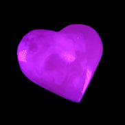 Mangano Calcite hand-carved heart 58g in UV light - Rocks and Things Store