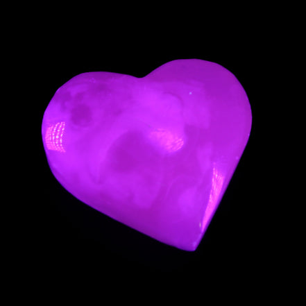 Mangano Calcite hand-carved heart 58g in UV light - Rocks and Things Store