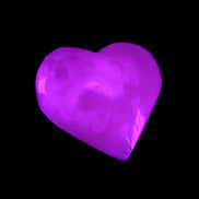 Mangano Calcite hand-carved heart 58g in UV light - Rocks and Things Store