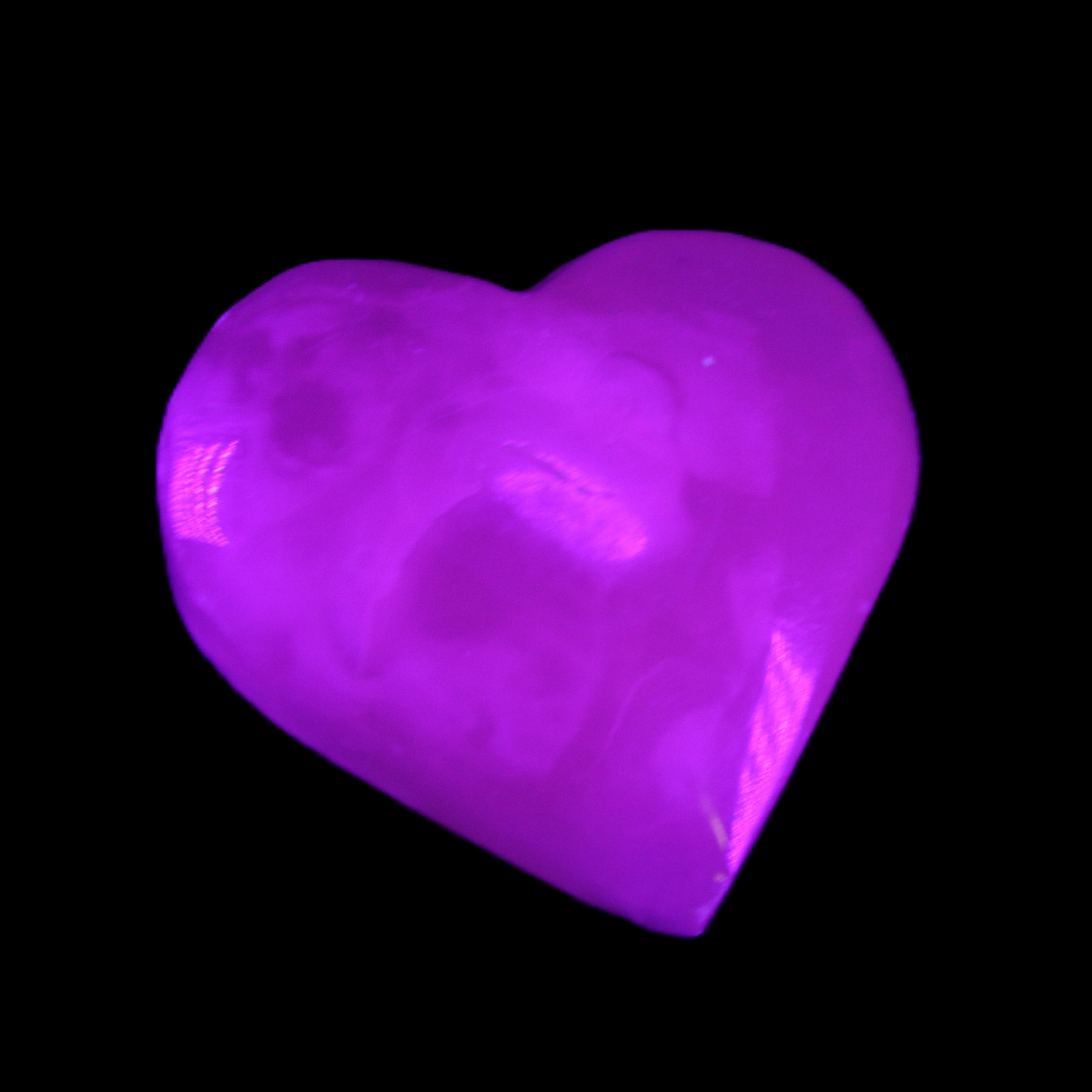 Mangano Calcite hand-carved heart 58g in UV light - Rocks and Things Store
