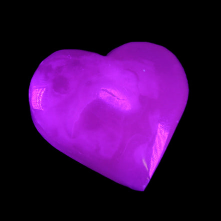 Mangano Calcite hand-carved heart 58g in UV light - Rocks and Things Store
