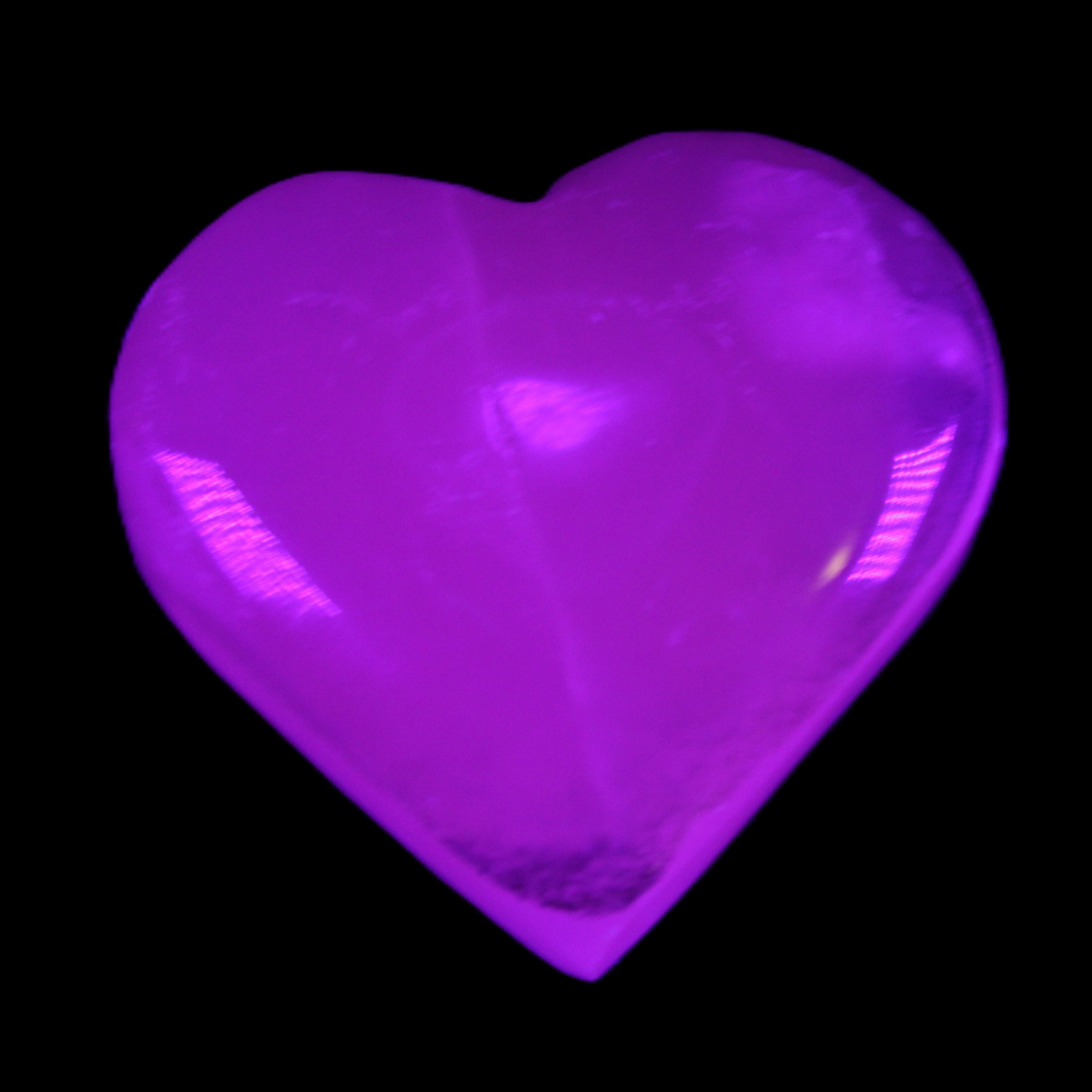 Mangano Calcite hand-carved heart 58g in UV light - Rocks and Things Store