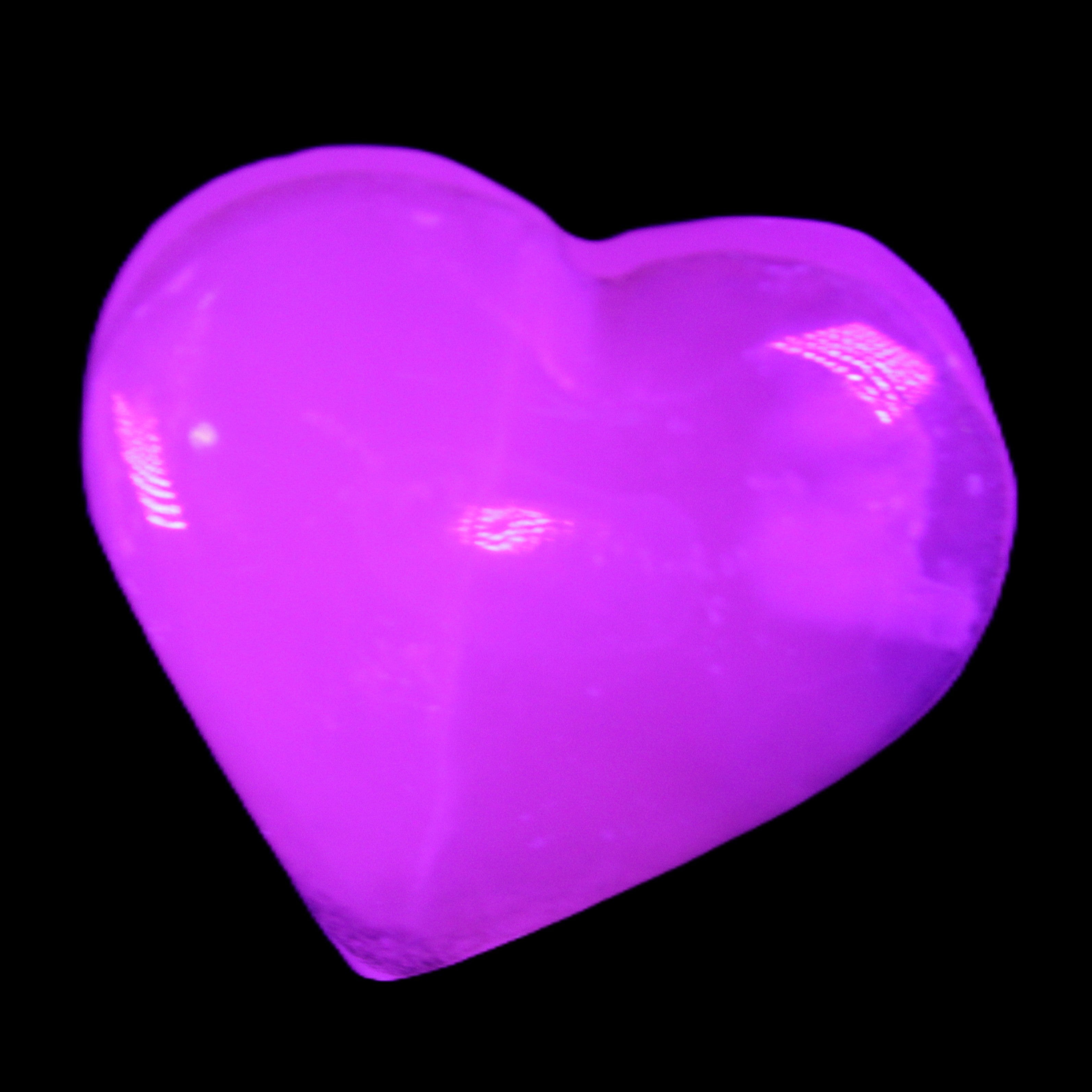 Mangano Calcite hand-carved heart 58g in UV light - Rocks and Things Store
