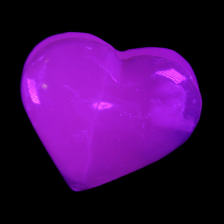 Mangano Calcite hand-carved heart 58g in UV light - Rocks and Things Store