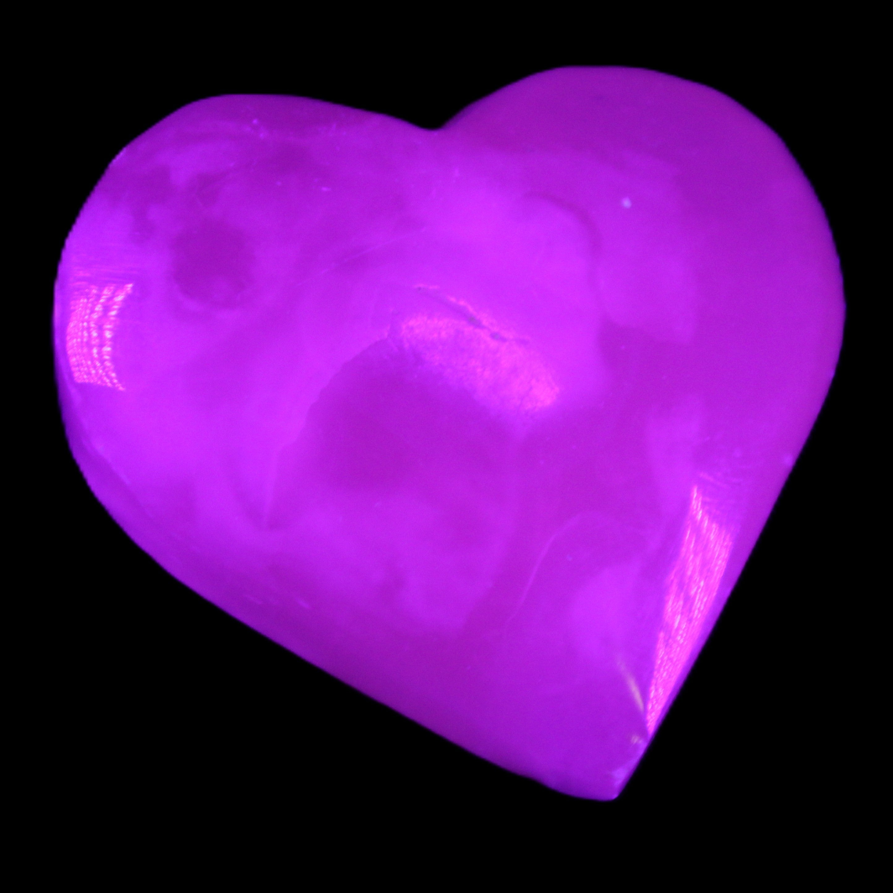 Mangano Calcite hand-carved heart 58g in UV light - Rocks and Things Store