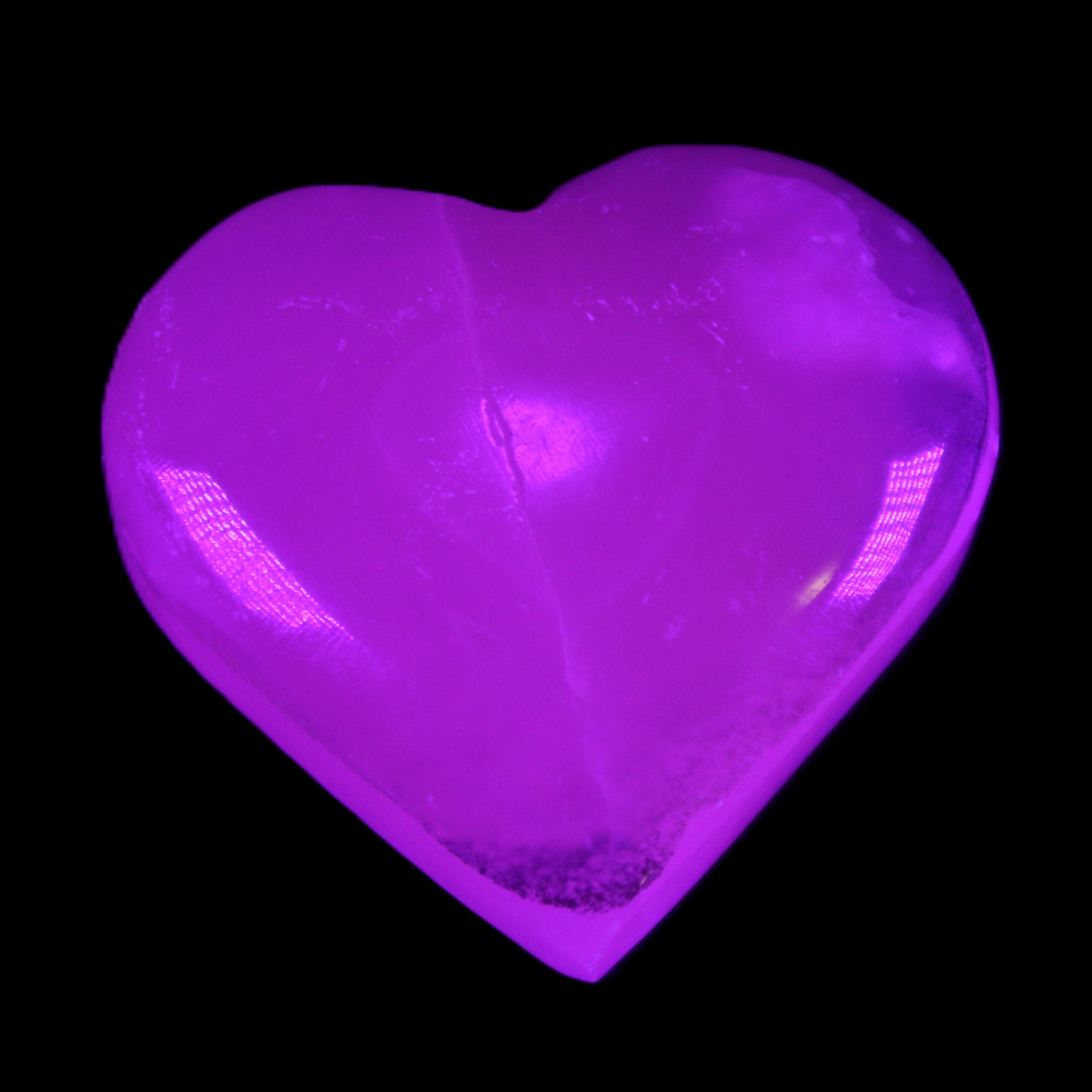 Mangano Calcite hand-carved heart 58g in UV light - Rocks and Things Store