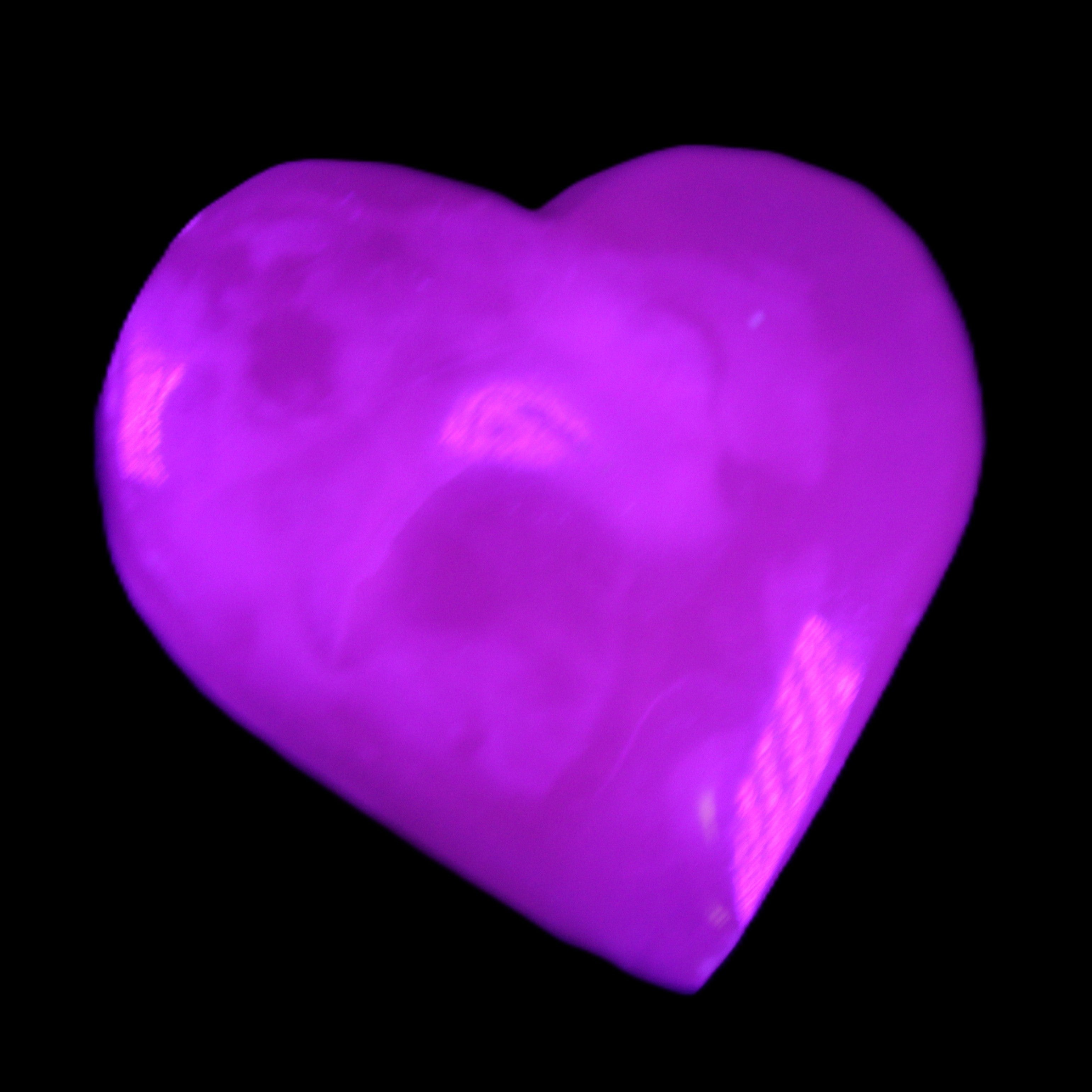 Mangano Calcite hand-carved heart 58g in UV light - Rocks and Things Store