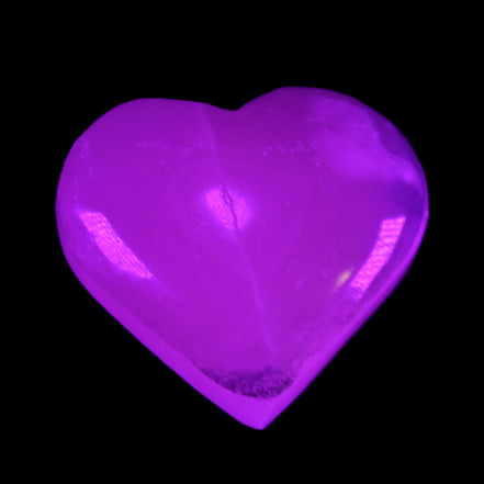 Mangano Calcite hand-carved heart 58g in UV light - Rocks and Things Store