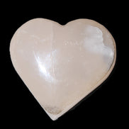 Mangano Calcite hand-carved heart 58g in sunlight - Rocks and Things Store