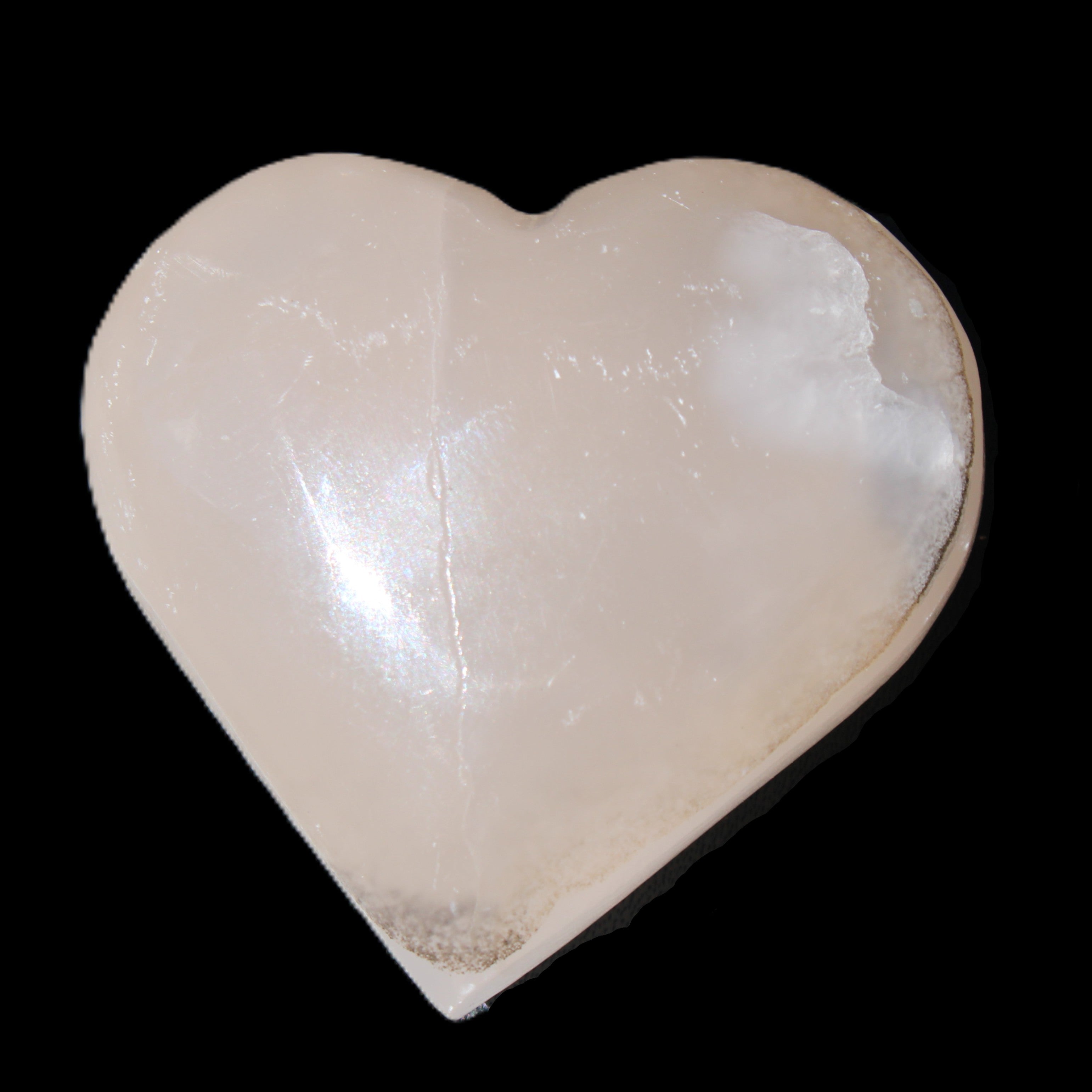 Mangano Calcite hand-carved heart 58g in sunlight - Rocks and Things Store