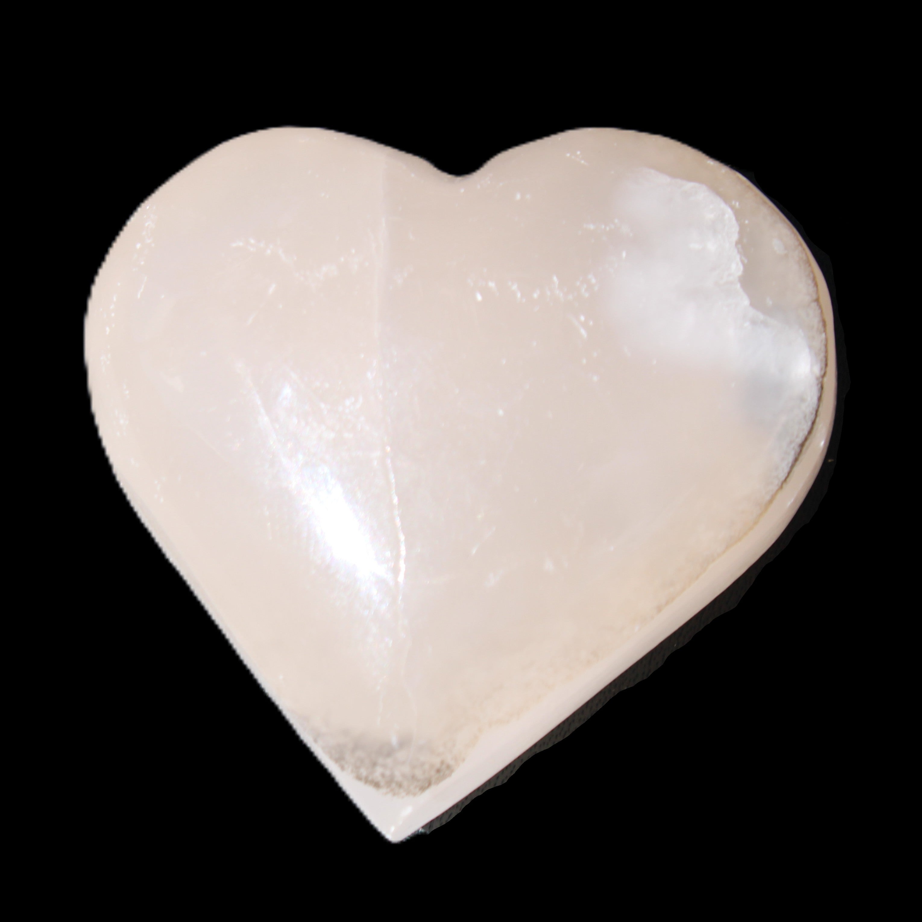 Mangano Calcite hand-carved heart 58g in sunlight - Rocks and Things Store