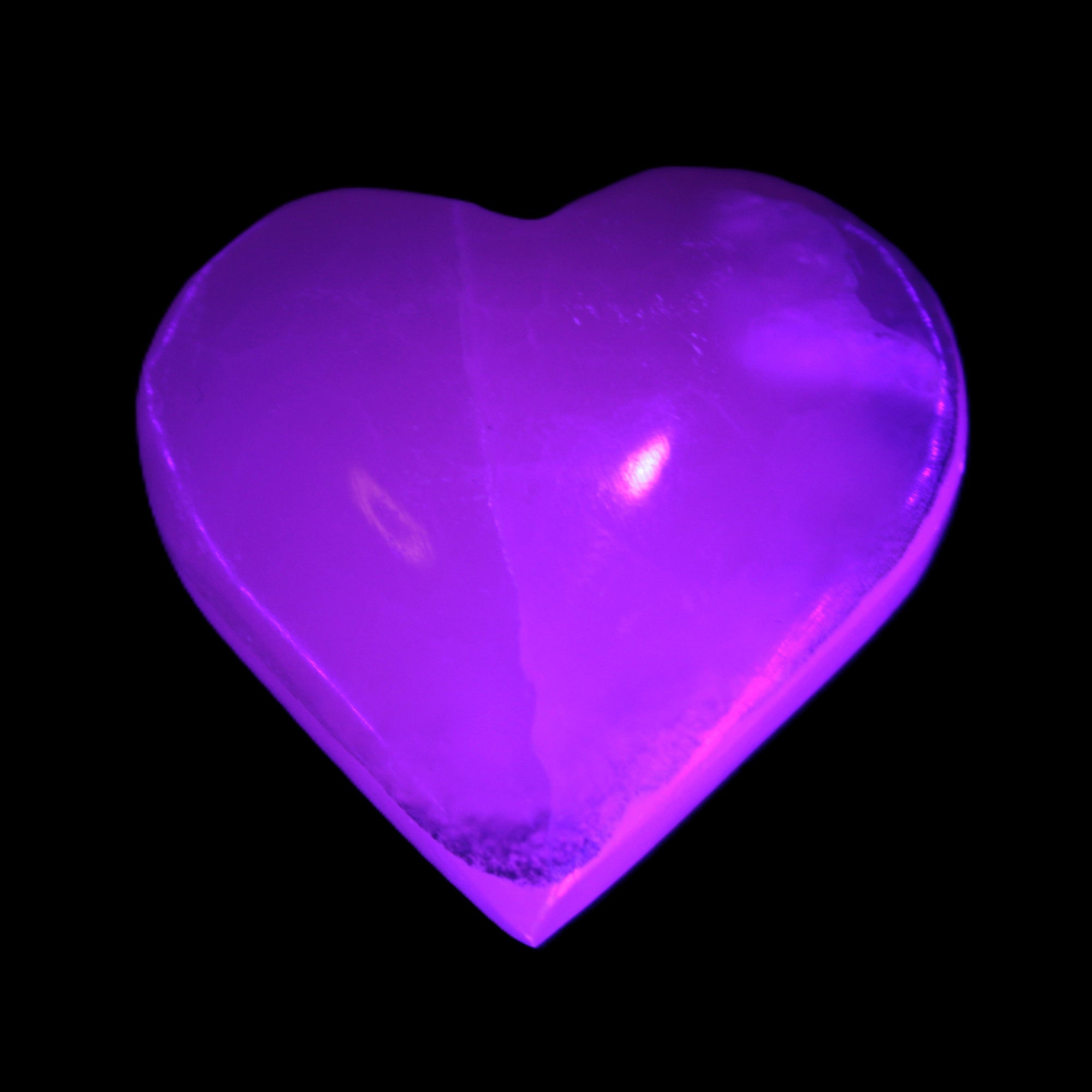 Mangano Calcite hand-carved heart 47-49mm 58-66g in UV light - Rocks and Things Store