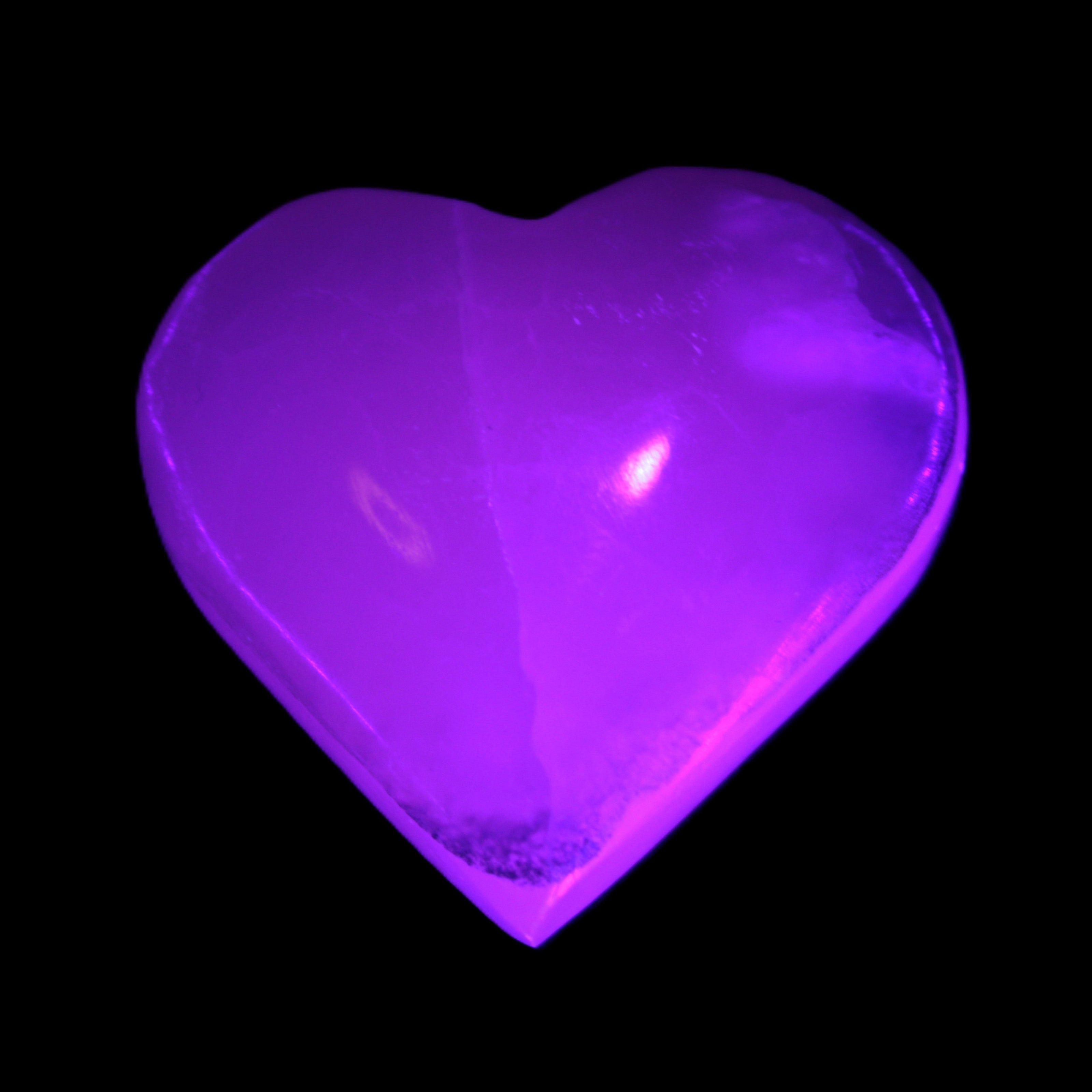 Mangano Calcite hand-carved heart 47-49mm 58-66g in UV light - Rocks and Things Store