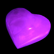 Mangano Calcite hand-carved heart 47-49mm 58-66g in UV light - Rocks and Things Store
