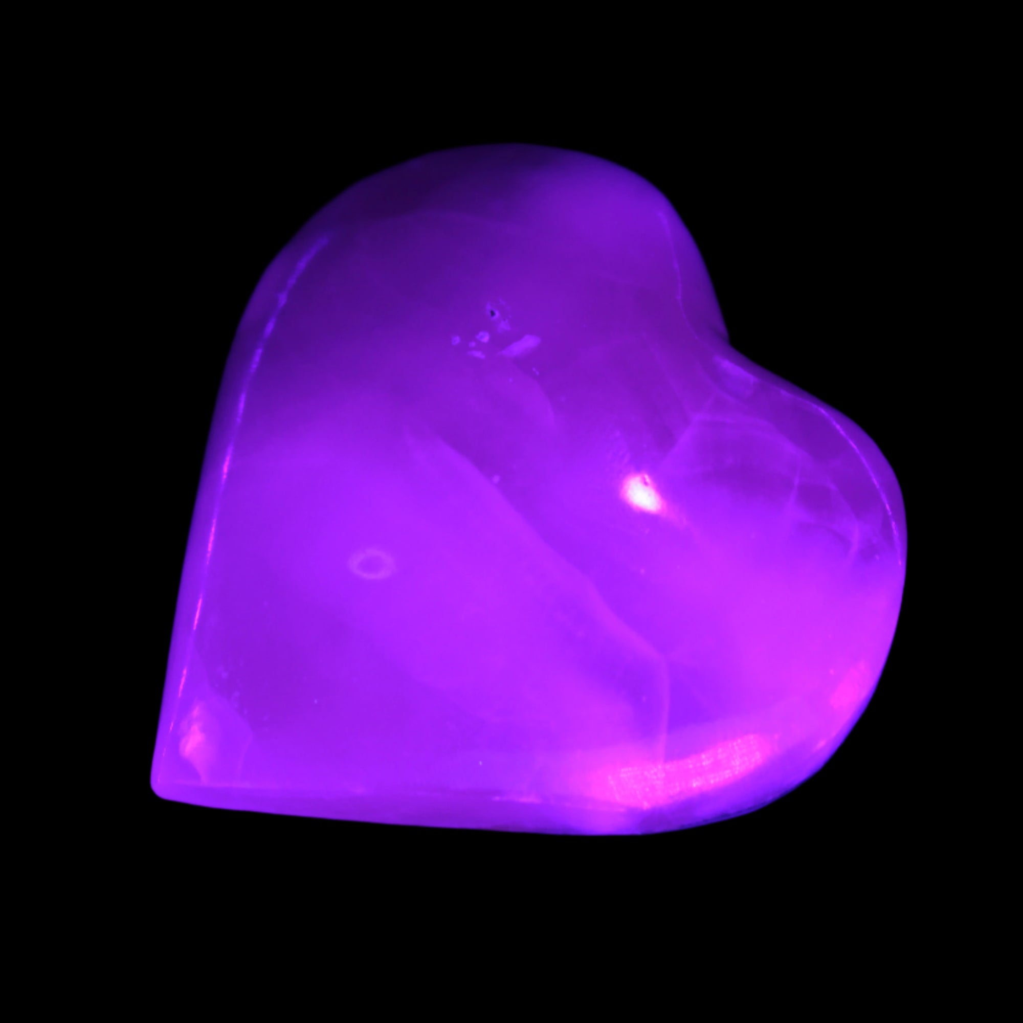 Mangano Calcite hand-carved heart 47-49mm 58-66g in UV light - Rocks and Things Store