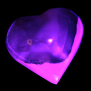 Mangano Calcite hand-carved heart 47-49mm 58-66g in UV light - Rocks and Things Store