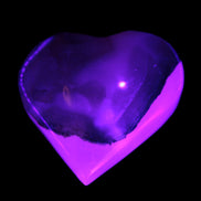 Mangano Calcite hand-carved heart 47-49mm 58-66g in UV light - Rocks and Things Store