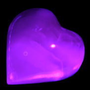 MMangano Calcite hand-carved heart 47-49mm 58-66g in UV light - Rocks and Things Store
