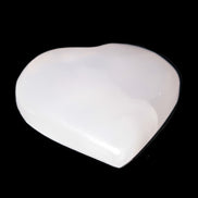 Pink Mangano Calcite heart 41-44mm 44-49g in sunlight -  Rocks and Things Store