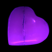 Mangano Calcite hand-carved heart 35-41mm 33-40g in UV light - Rocks and Things Store