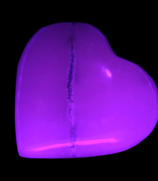 Mangano Calcite hand-carved heart 35-41mm 33-40g in UV light - Rocks and Things Store