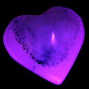 Mangano Calcite hand-carved heart 35-41mm 33-40g in UV light - Rocks and Things Store