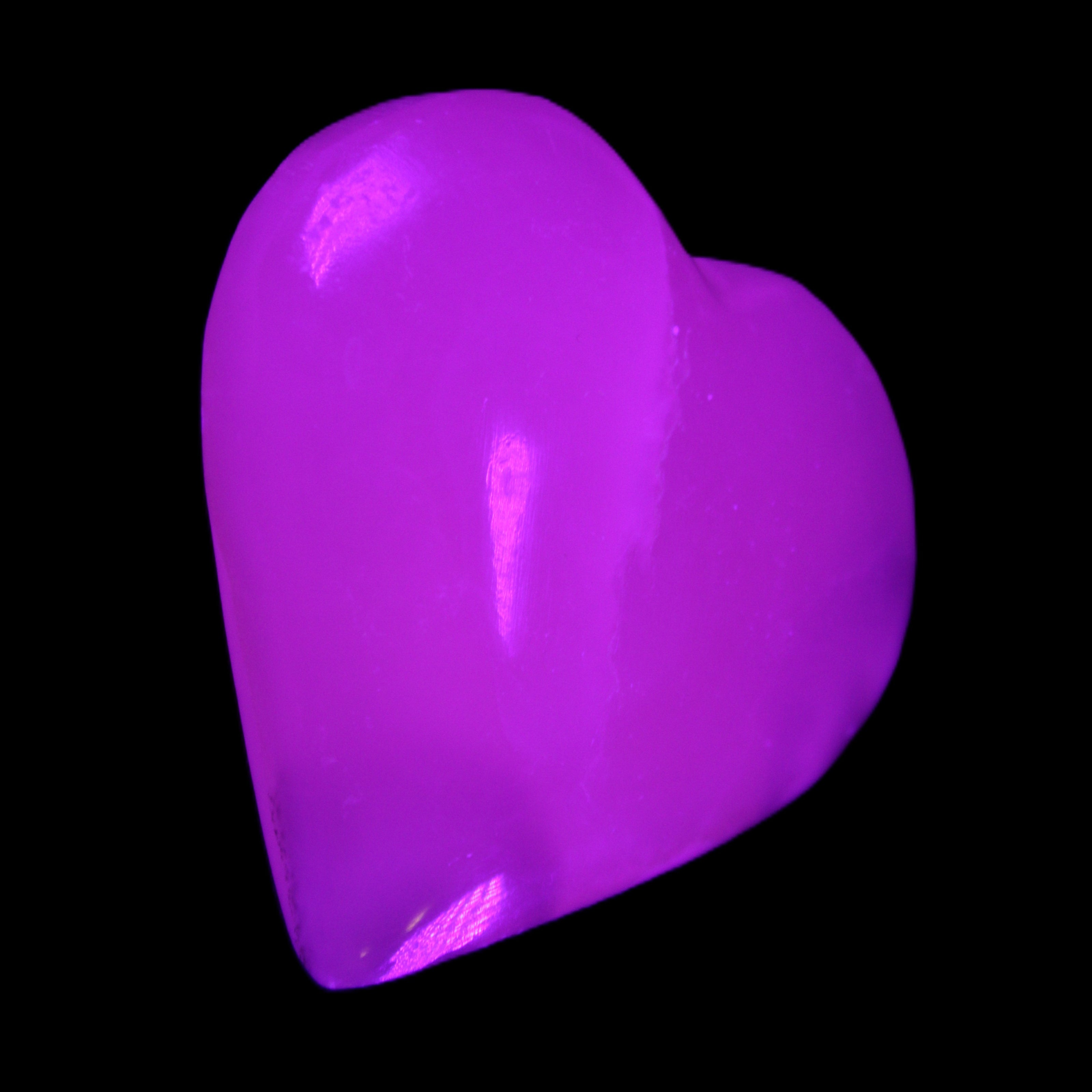 Mangano Calcite hand-carved heart 67*64mm 125g in UV light - Rocks and Things Store