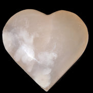 Mangano Calcite hand-carved heart 67*64mm  125g in sunlight - Rocks and Things Store