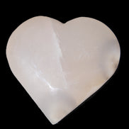 Mangano Calcite hand-carved heart 67*64mm  125g in sunlight - Rocks and Things Store
