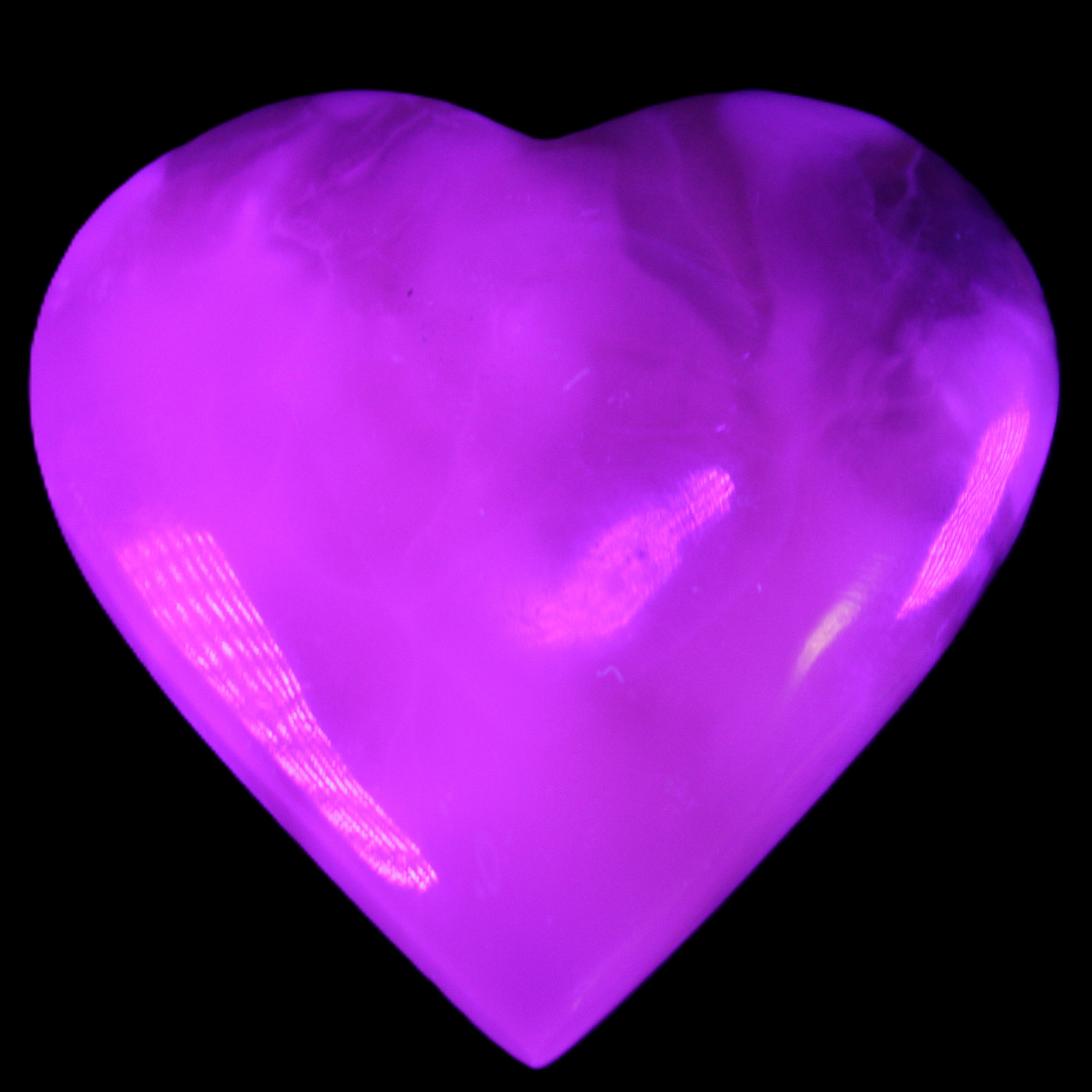 Mangano Calcite hand-carved heart 73*78*20mm 160g in UV light - Rocks and Things Store
