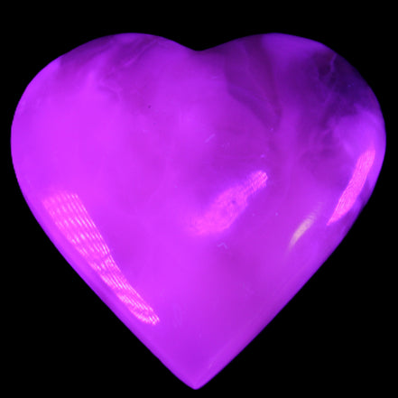Mangano Calcite hand-carved heart 73*78*20mm 160g in UV light - Rocks and Things Store