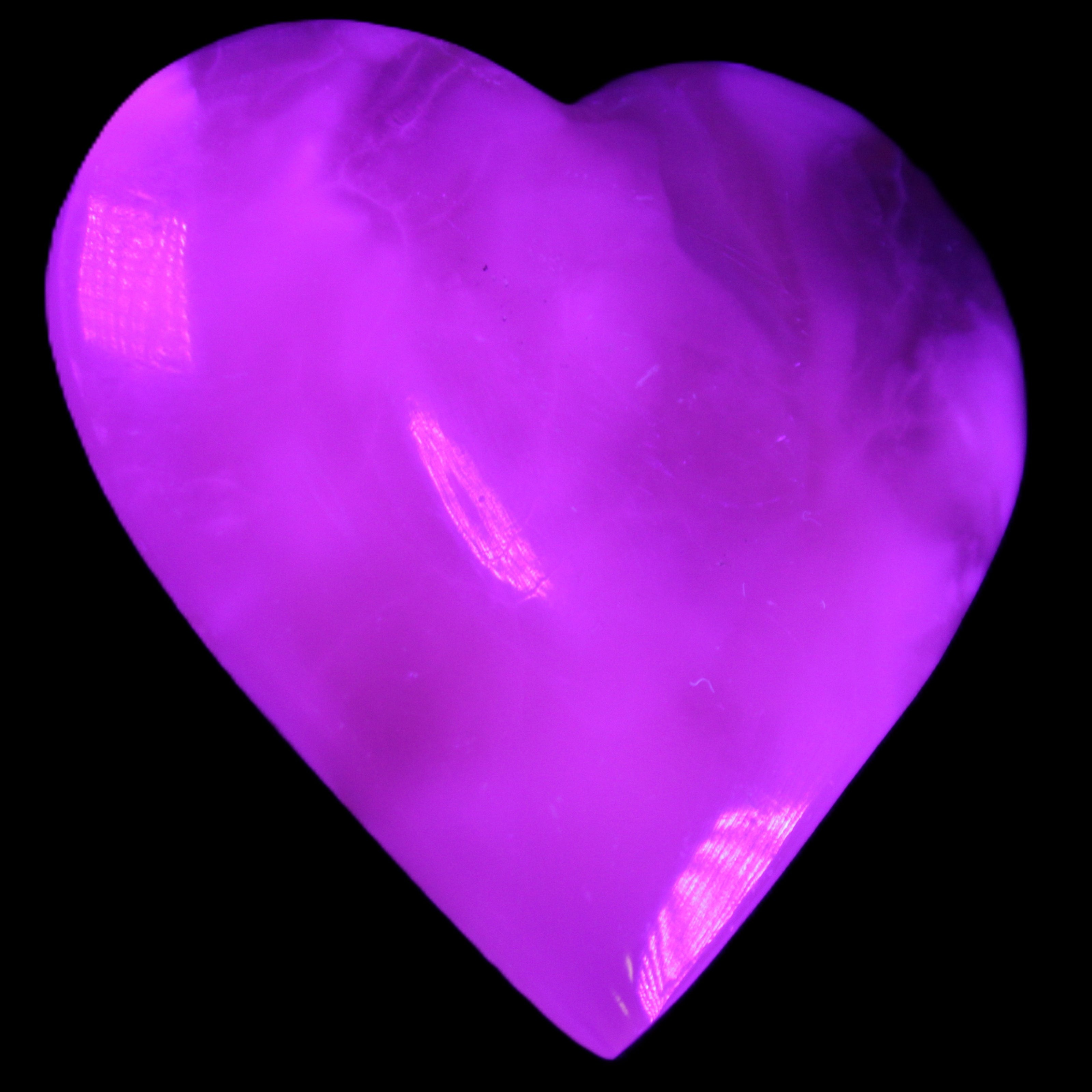 Mangano Calcite hand-carved heart 73*78*20mm 160g in UV light - Rocks and Things Store