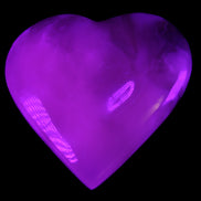 Mangano Calcite hand-carved heart 73*78*20mm 160g in UV light - Rocks and Things Store
