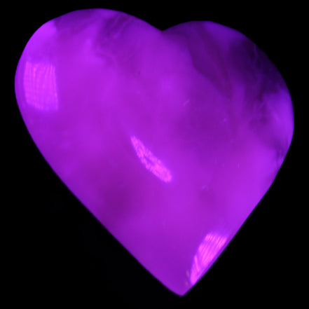 Mangano Calcite hand-carved heart 73*78*20mm 160g in UV light - Rocks and Things Store