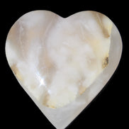 Mangano Calcite hand-carved heart 73*78*20mm 160g in sunlight - Rocks and Things Store